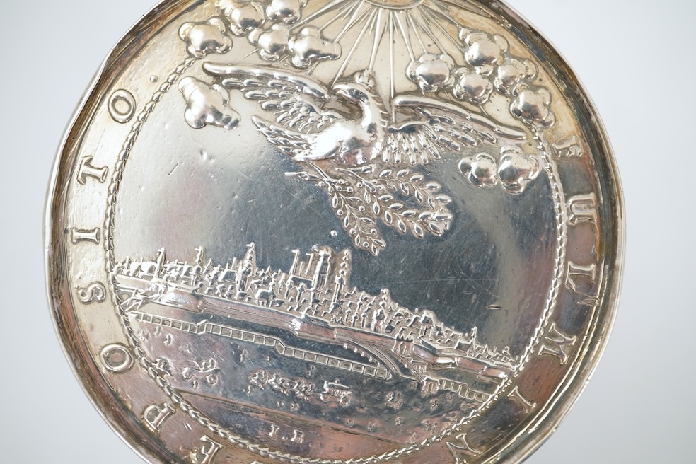 A white metal beaker the base inset with a silver medal commemorating the Peace of Oliva, 1660, Obv. Bird's-eye view of the city of Danzig with troops moving in foreground; above, an eagle crowned, an olive branch in its